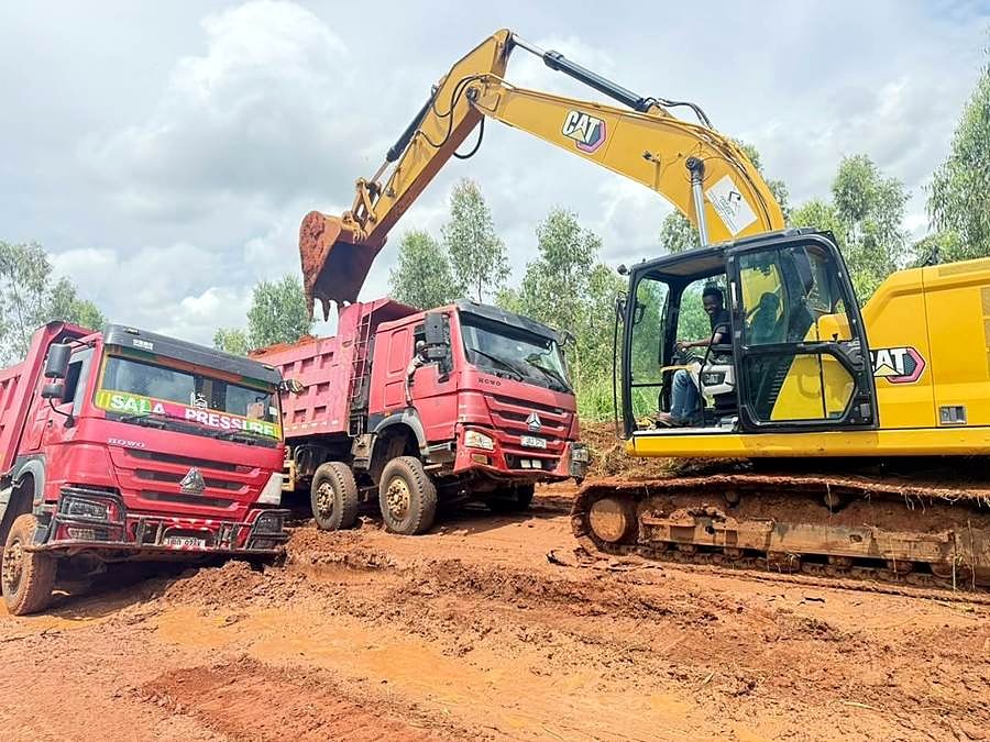 Excavator loading tipper trucks on an earthworks site