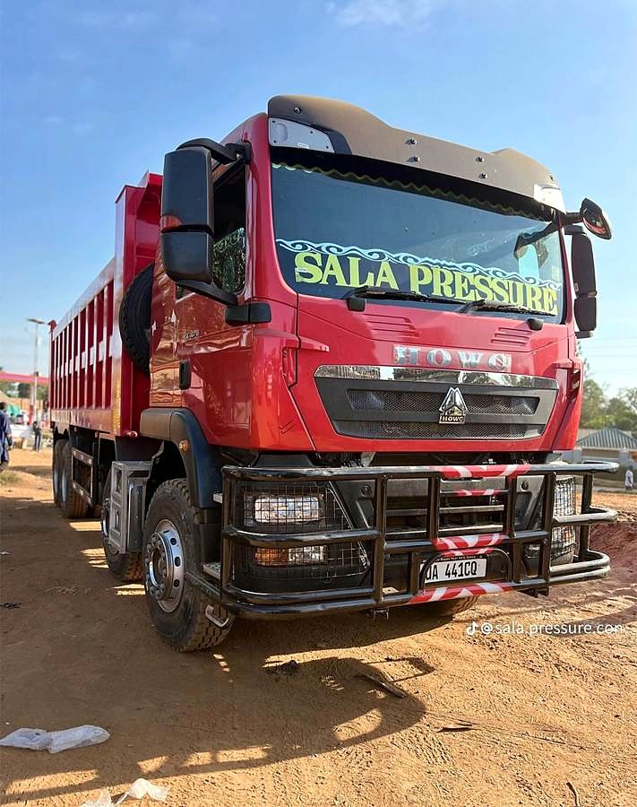 Red tipper truck, front view.
