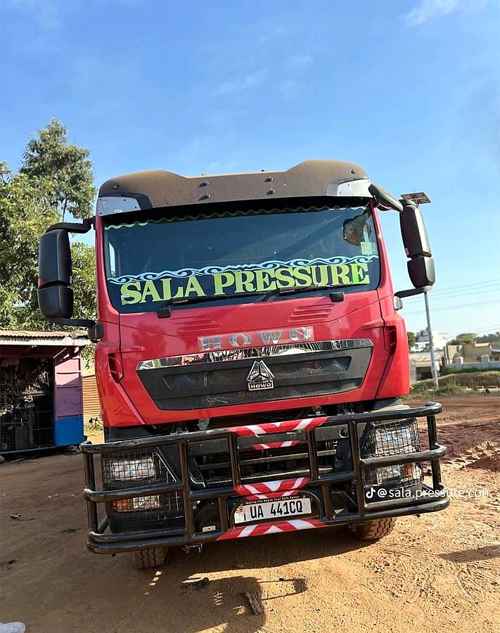 Red tipper truck with Sala Pressure windscreen banner.